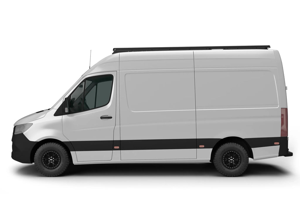 SIDE VIEW OF WHITE SPRINTER BUS WITH ROOF RACK