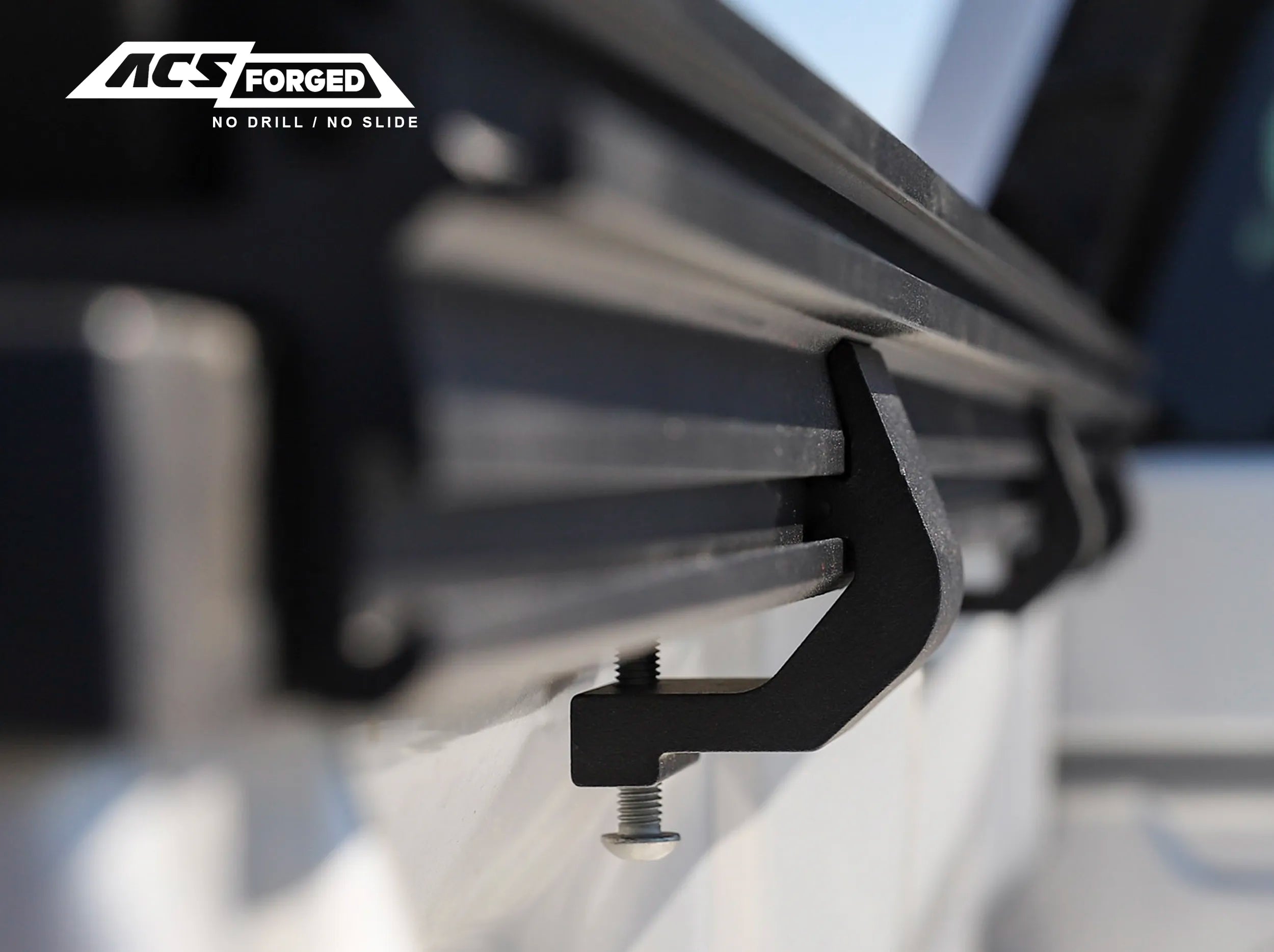 CLOSE UP VIEW OF CLAMPS ATTACHED TO SIDE RAIL OF ACS FORGED BED RACK 