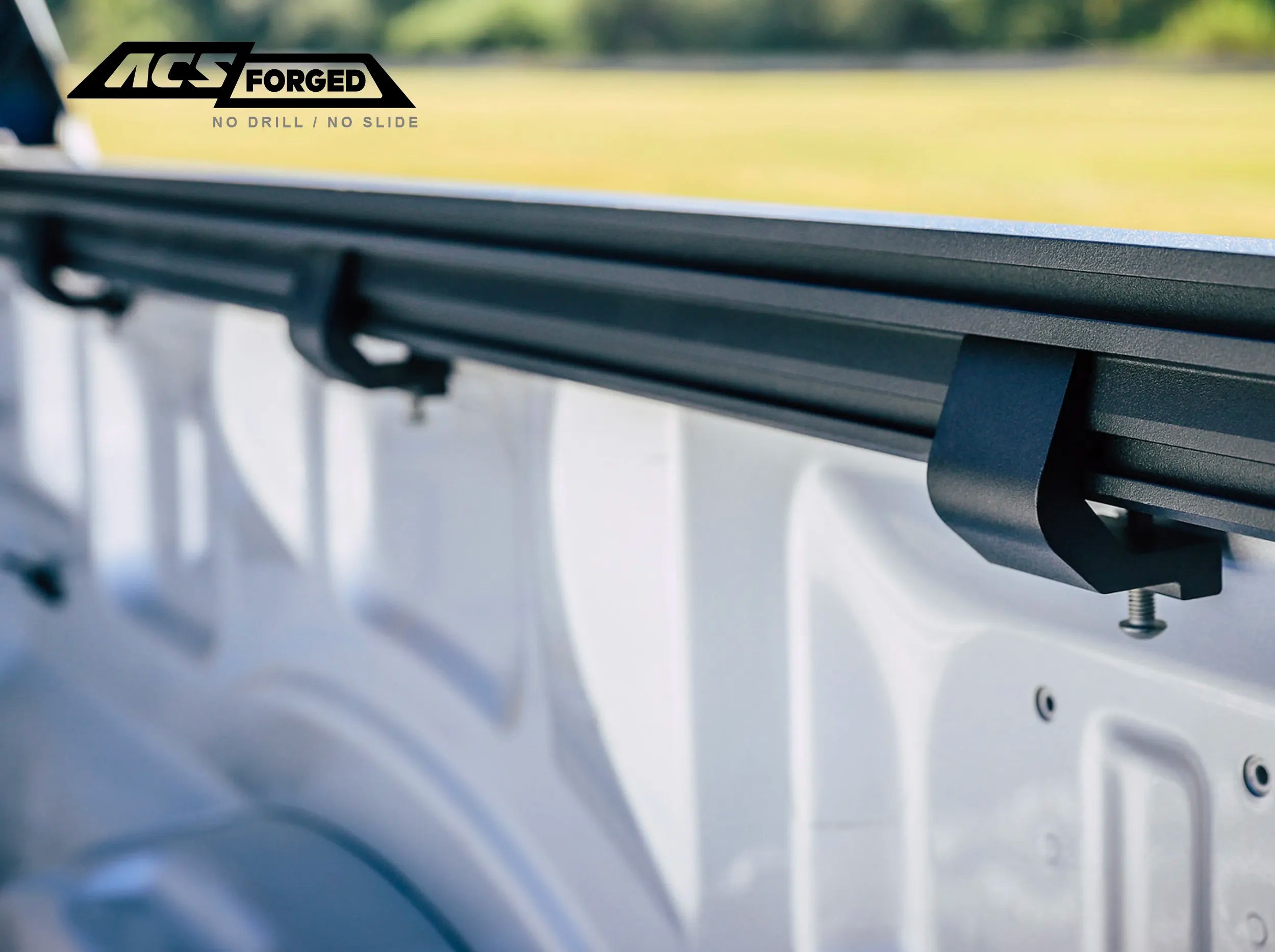 CLOSE UP VIEW OF CLAMPS ATTACHED TO SIDE RAIL OF ACS FORGED BED RACK 