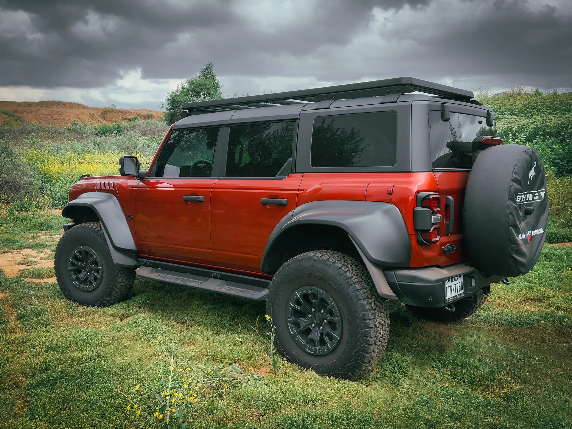 SIDE REAR VIEW OF RED FORD BRONCO OUTSIDE WITH ACS ROOF RACK INSTALLED