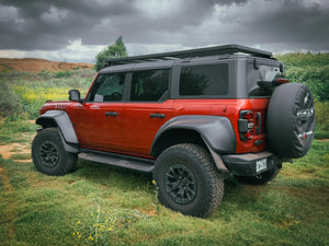 SIDE REAR VIEW OF RED FORD BRONCO OUTSIDE WITH ACS ROOF RACK INSTALLED