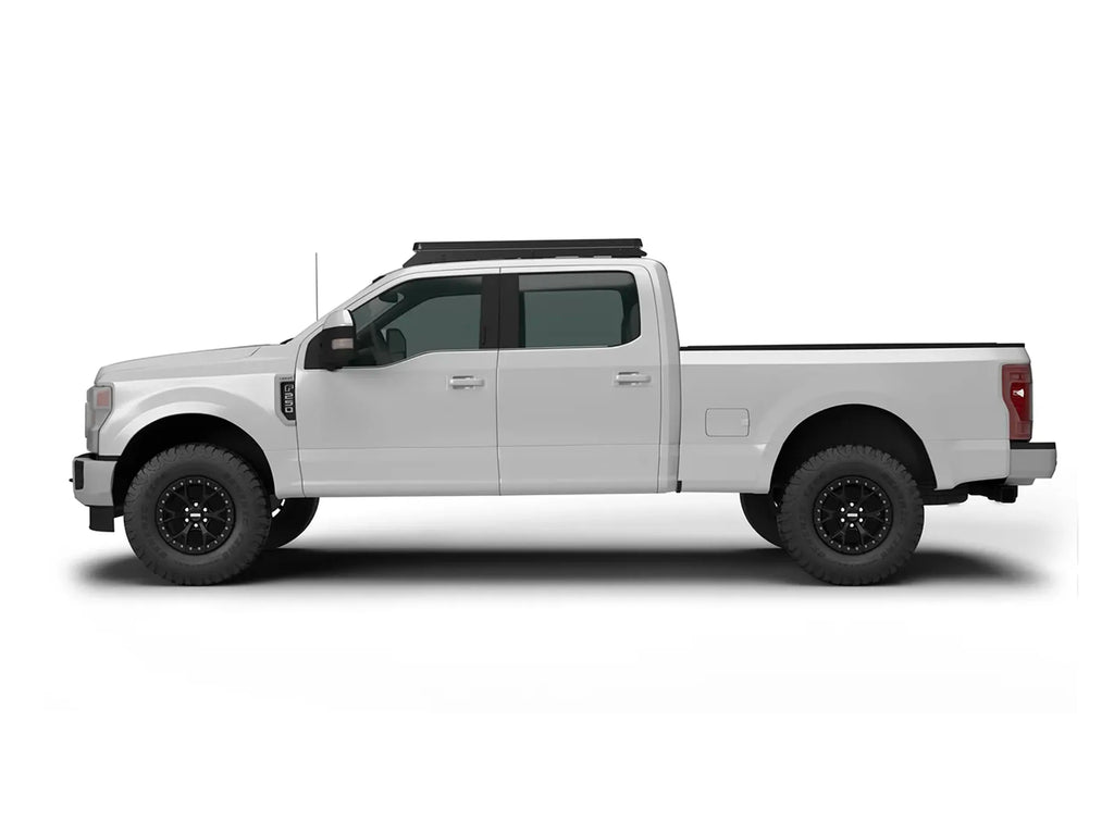 SIDE VIEW OF WHITE FORD SUPERDUTY TRUCK WITH ACS OVER CAB ROOF MOUNTED