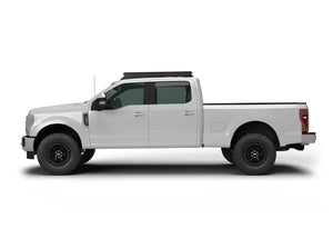 SIDE VIEW OF WHITE FORD SUPERDUTY TRUCK WITH ACS OVER CAB ROOF MOUNTED