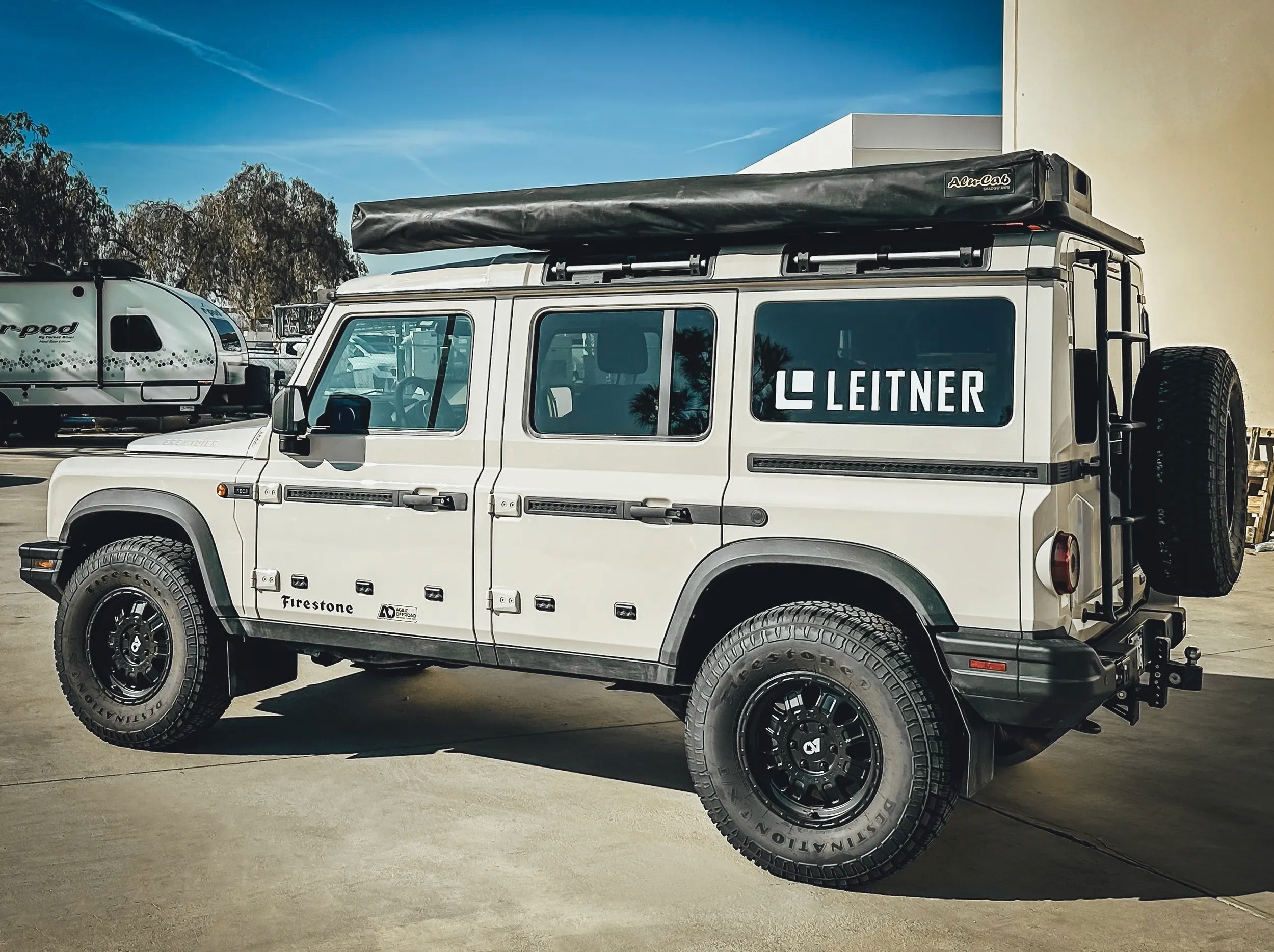 SIDE VIEW OF INEOS GRENADIER WITH ALU CAB AWNING MOUNTED TO GRENADIER ROOF RACK