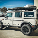 SIDE VIEW OF INEOS GRENADIER WITH ALU CAB AWNING MOUNTED TO GRENADIER ROOF RACK