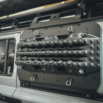 CLOSE UP VIEW OF BLACK RECOVERY BOARD MOUNTED ON SIDE KICK PANEL ON GRENADIER