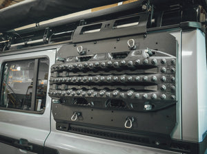 CLOSE UP VIEW OF BLACK RECOVERY BOARD MOUNTED ON SIDE KICK PANEL ON GRENADIER