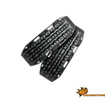 black recovery boards with raised traction lugs, designed to help vehicles gain traction in sand, mud, or snow