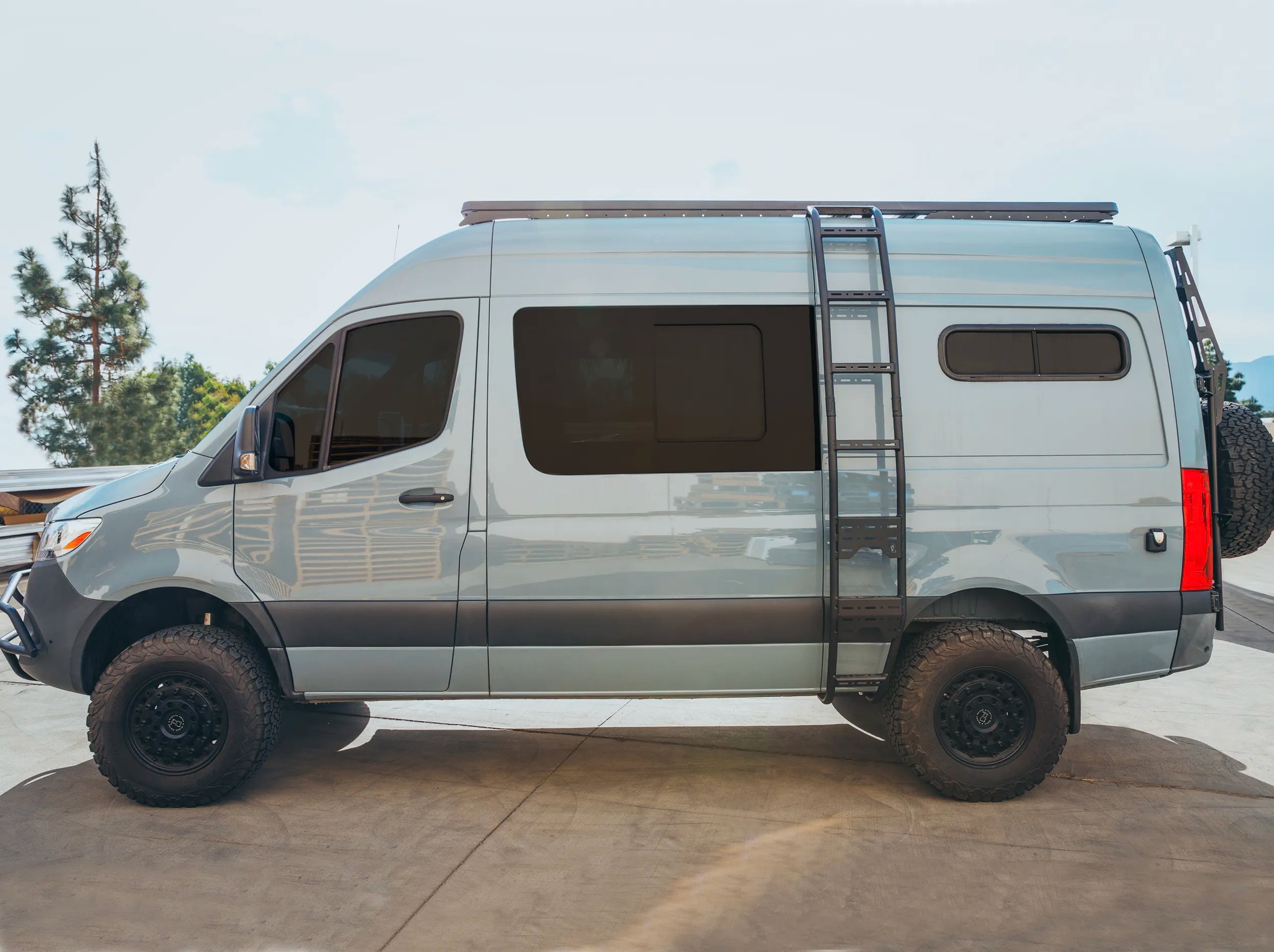 SIDE VIEW OF SPRINTER BUS WITH ROOF RACK MOUNTED 