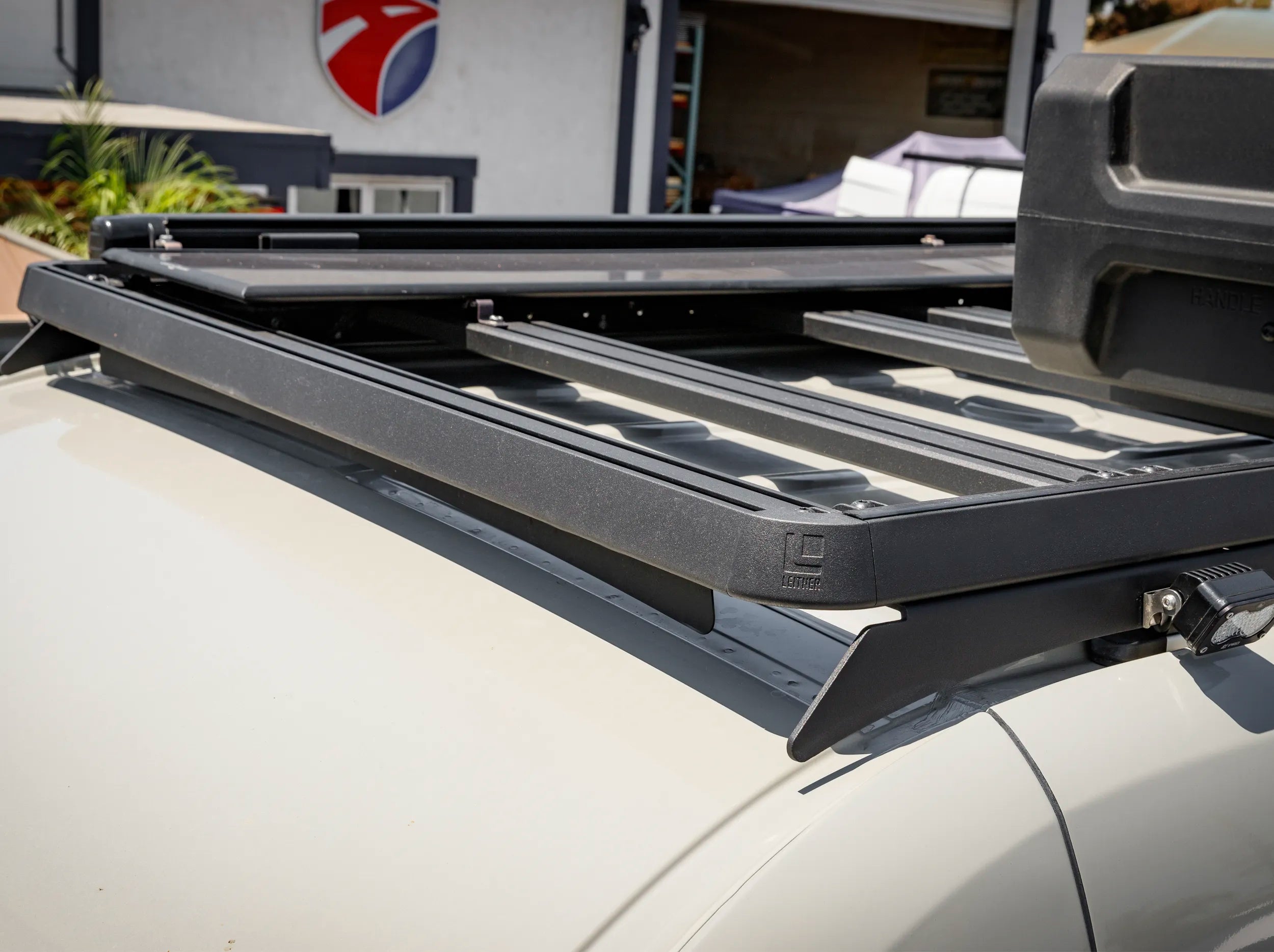 CLOSE UP OF BLACK ROOF RACK FOR SPRINTER BUS