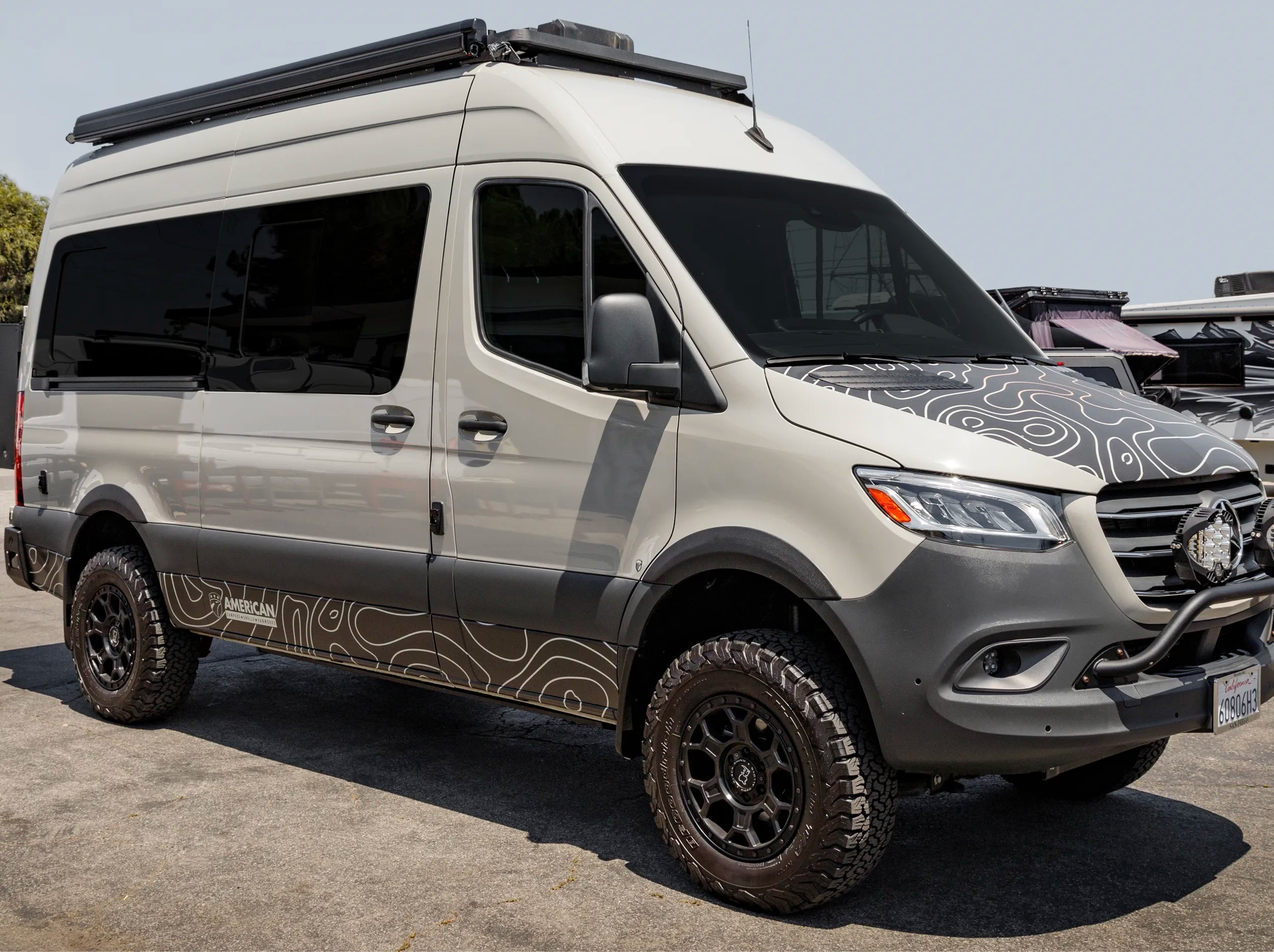 SIDE VIEW OF SPRINTER BUS WITH ROOF RACK 