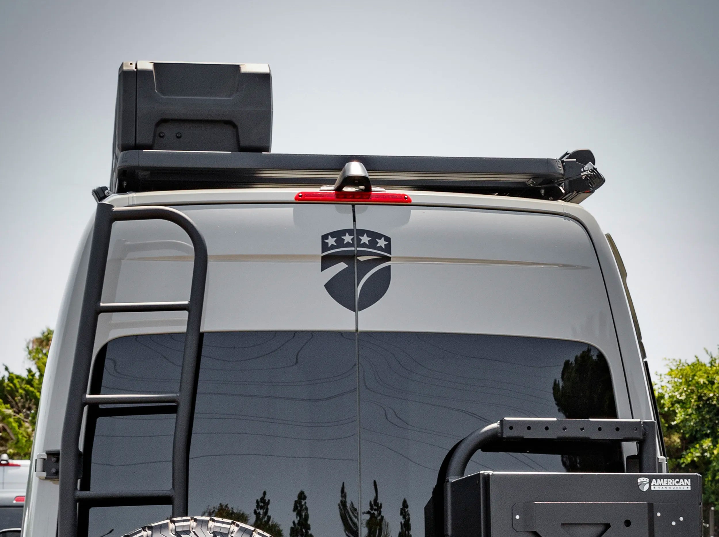 REAR VIEW OF SPRINTER BUS WITH ROOF RACK AND GEARPOD ROOFS MOUNTED