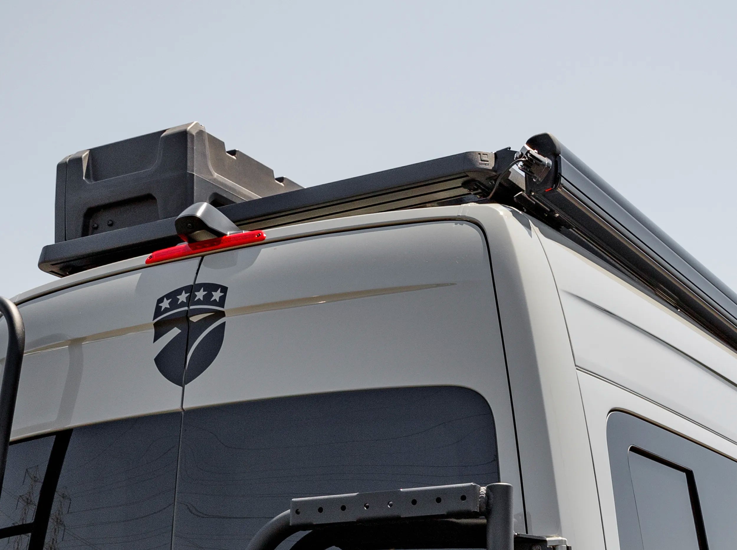 REAR VIEW OF SPRINTER BUS WITH ROOF RACK AND GEARPOD ROOF 